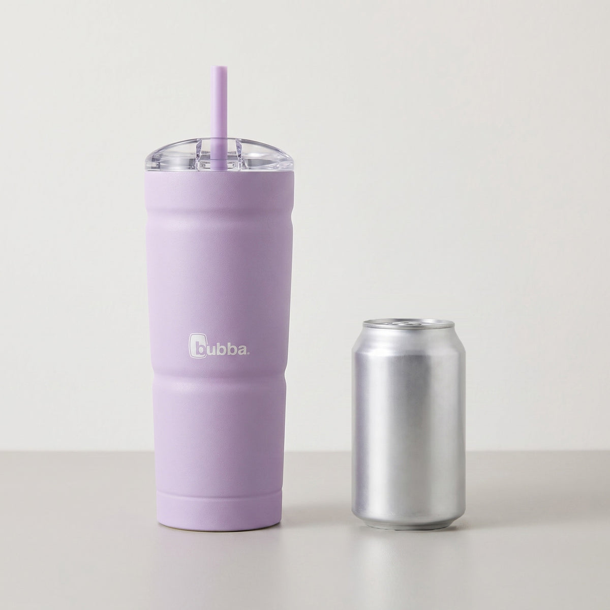 bubba 24 oz Envy S Tumbler in Lavender Frost standing beside a 355 ml can for size comparison. It stands 9 in tall (10.5 in with the straw up).
