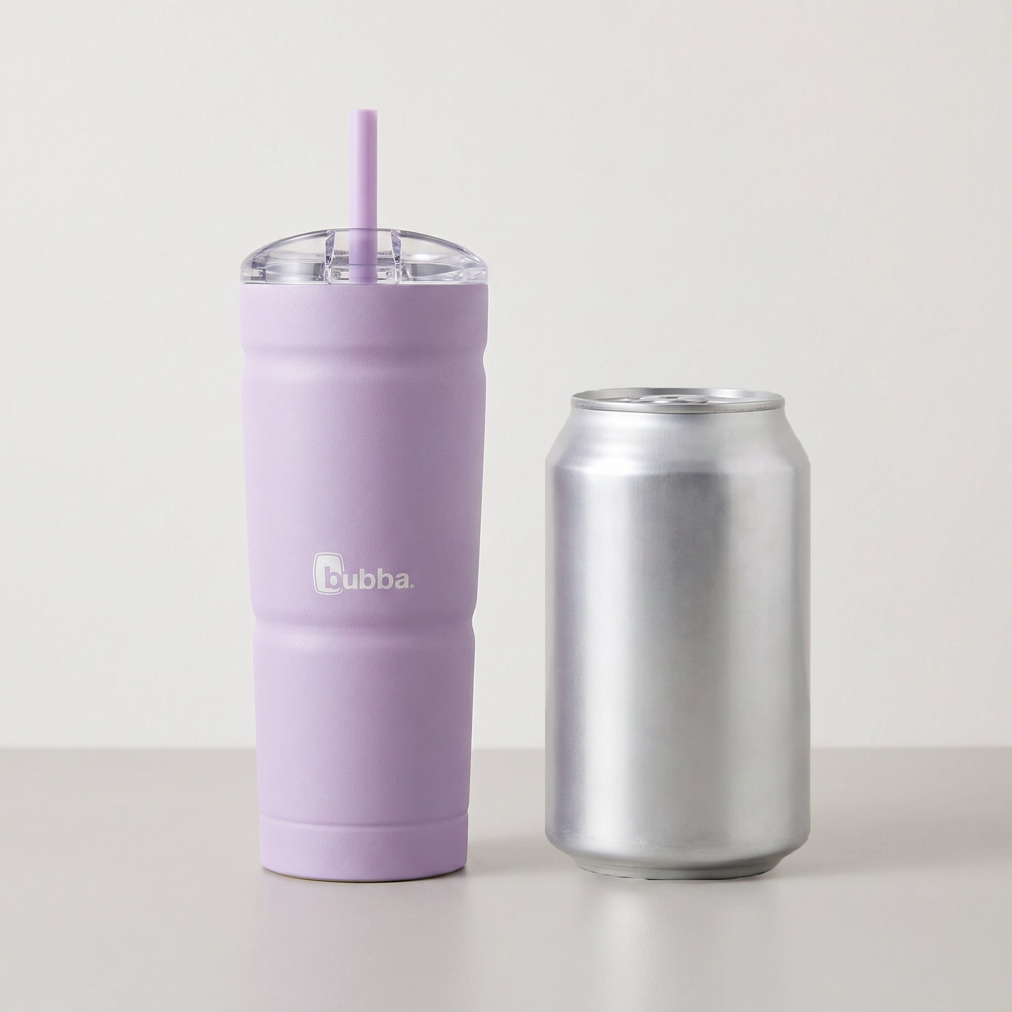 bubba 24 oz Envy S Tumbler in Lavender Frost standing beside a 355 ml can for size comparison. It stands 7.5 in tall.