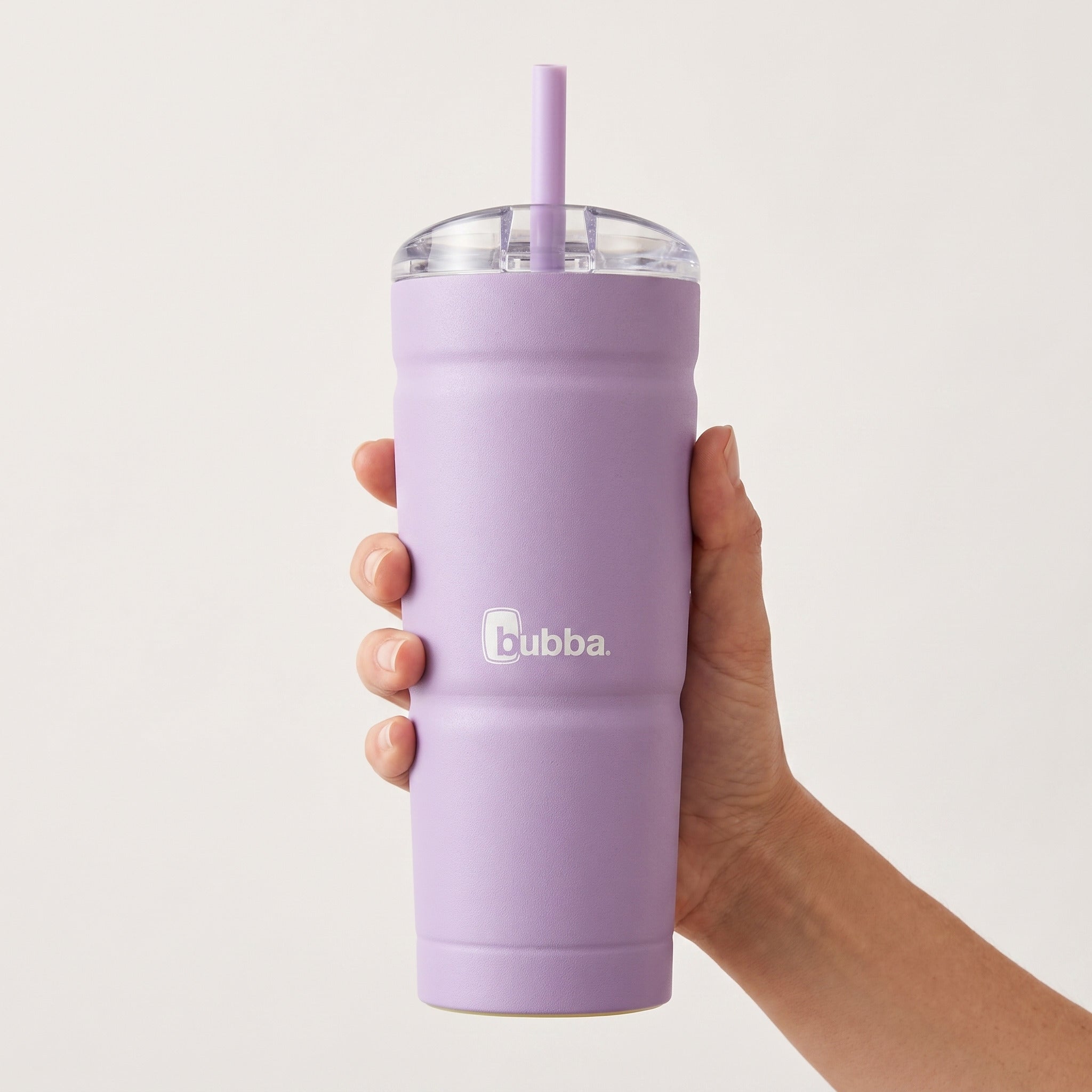 bubba 24 oz Envy S Tumbler in Lavender Frost held in an adult hand, showing its real size. It stands 7.5 in tall.