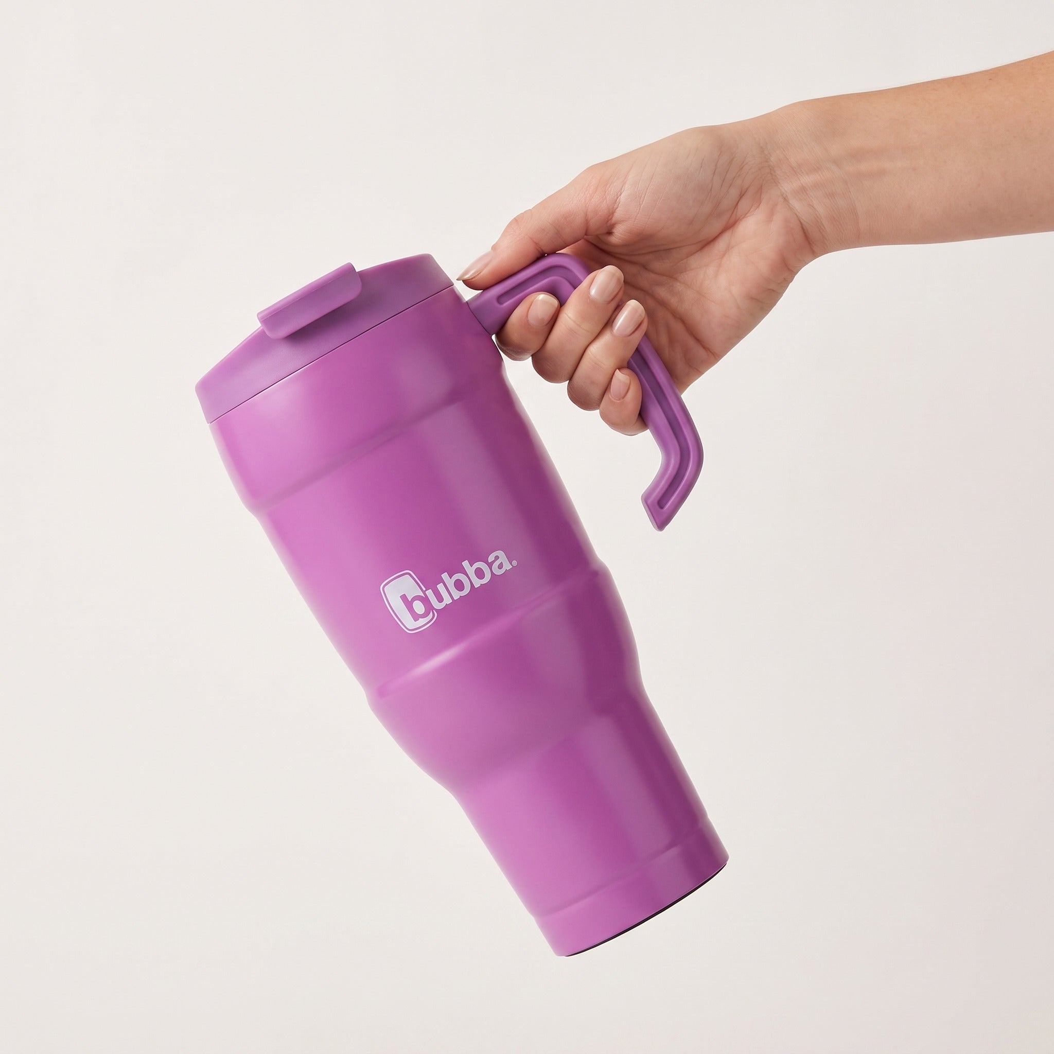 bubba 24 oz Hero XL Tumbler in Magenta/Galactic held in an adult hand, showing its real size. It stands 10.0 in tall.