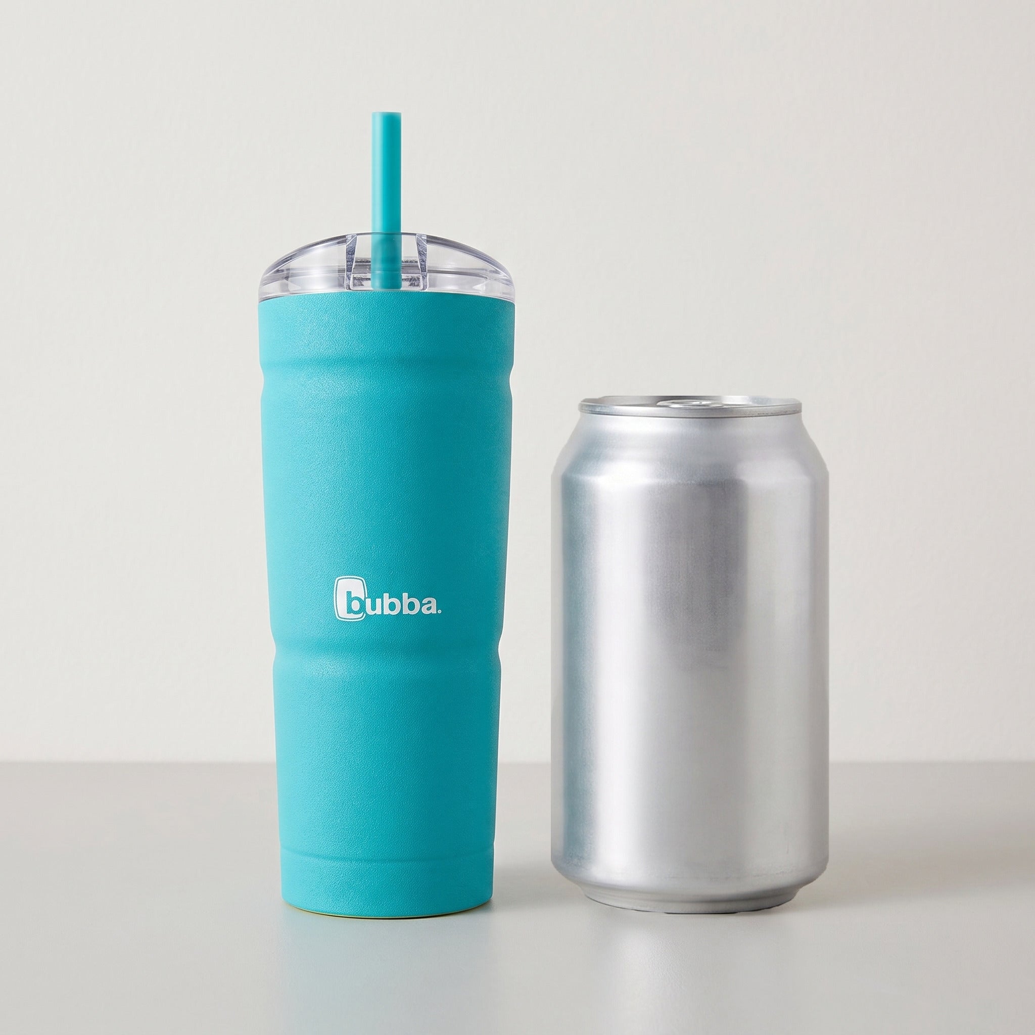 bubba 24 oz Envy S Tumbler in Scuba standing beside a 355 ml can for size comparison. It stands 7.5 in tall.