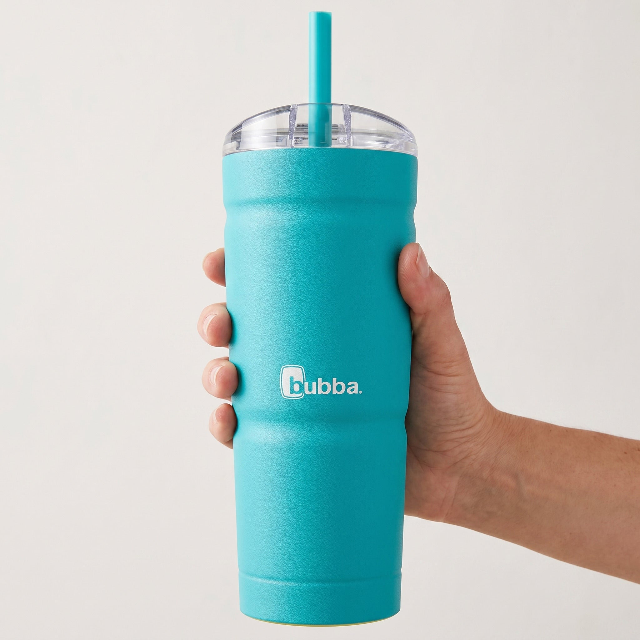 bubba 24 oz Envy S Tumbler in Scuba held in an adult hand, showing its real size. It stands 7.5 in tall.