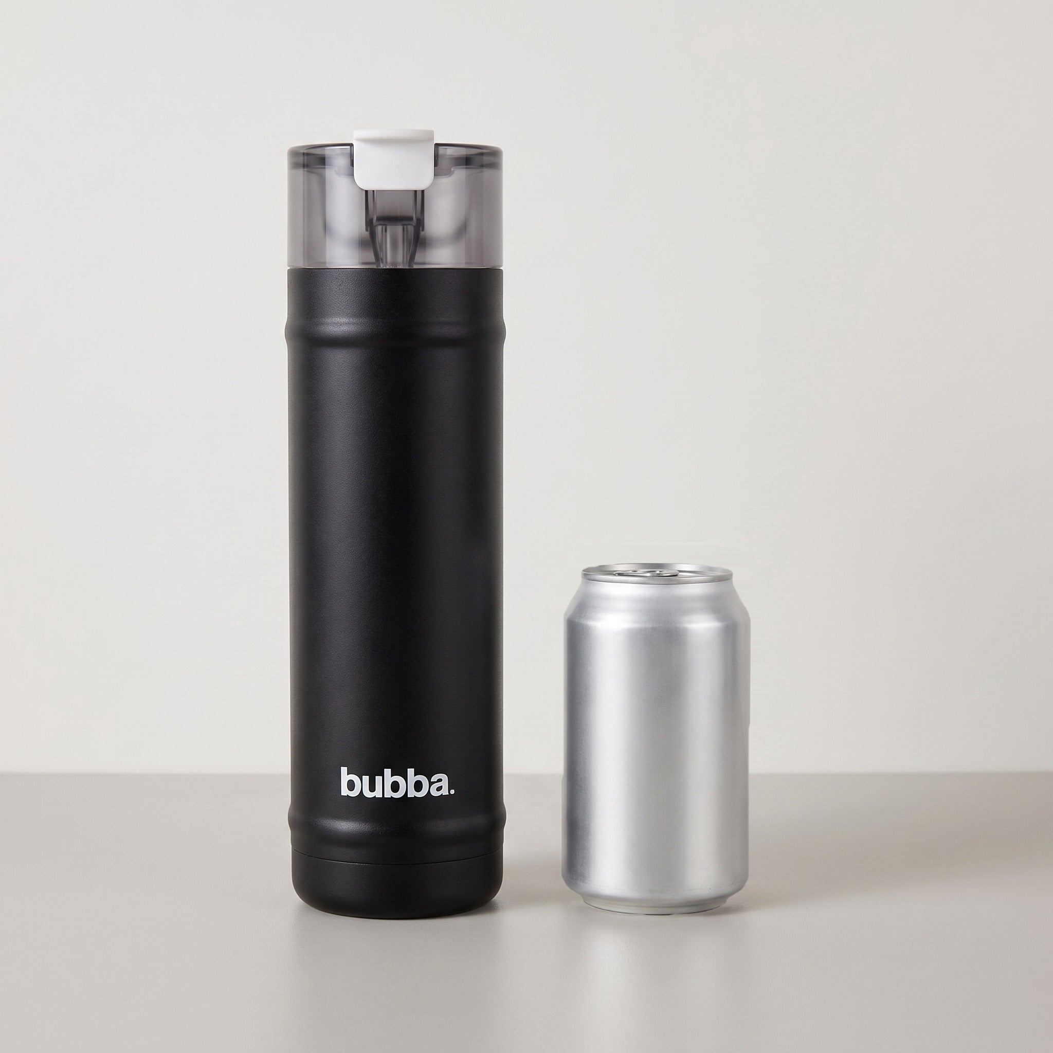 bubba 24 oz DualSip insulated bottle in Office Siren standing beside a 355 ml can for size comparison. It stands 10.79 in tall.