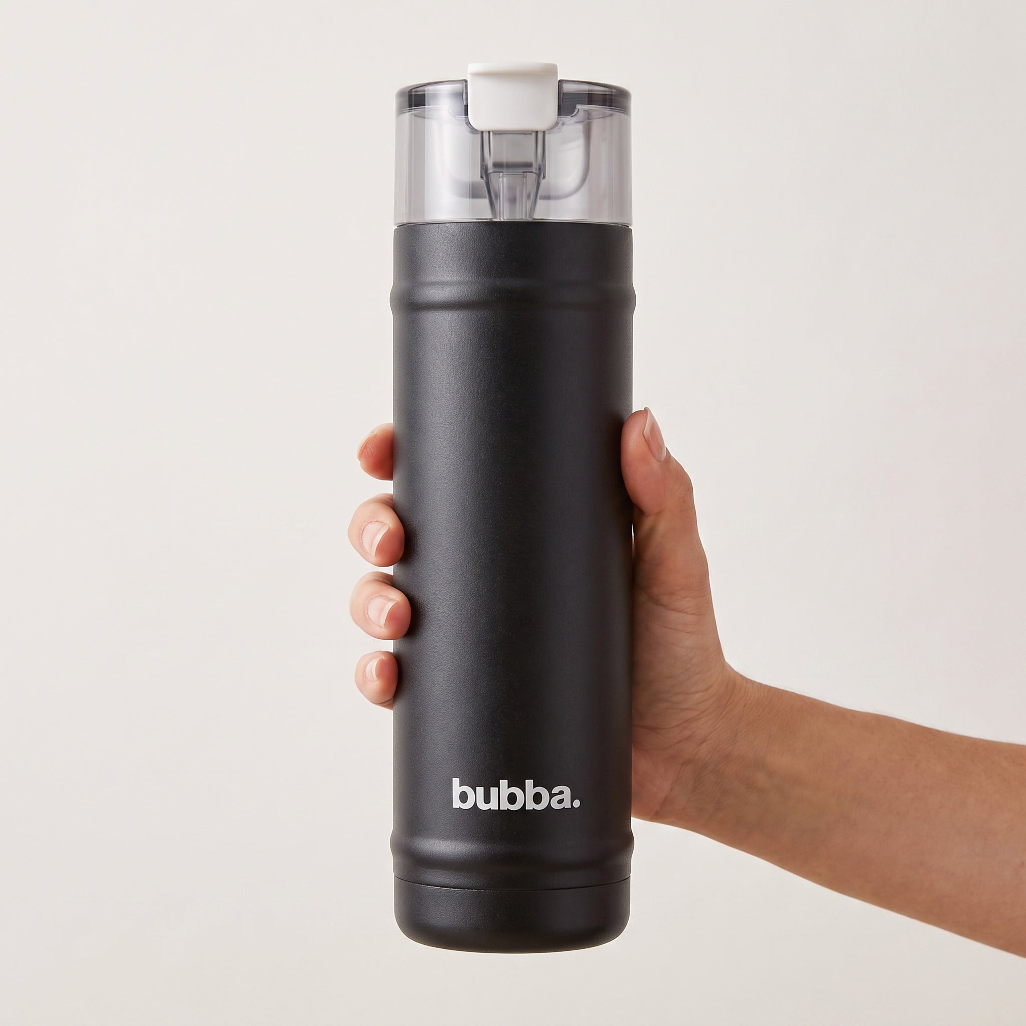 bubba 24 oz DualSip insulated bottle in Office Siren held in an adult hand, showing its real size. It stands 10.79 in tall.