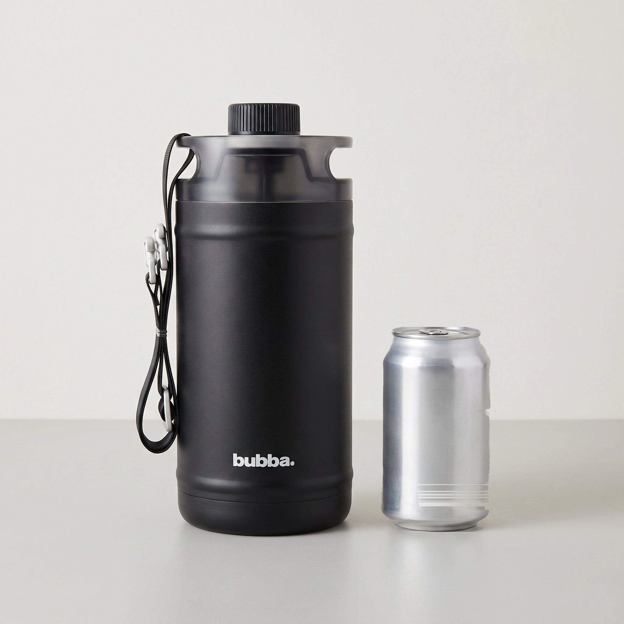 bubba 64 oz Insulated Jug in Office Siren standing beside a 355 ml can for size comparison. It stands 10.2 in tall.
