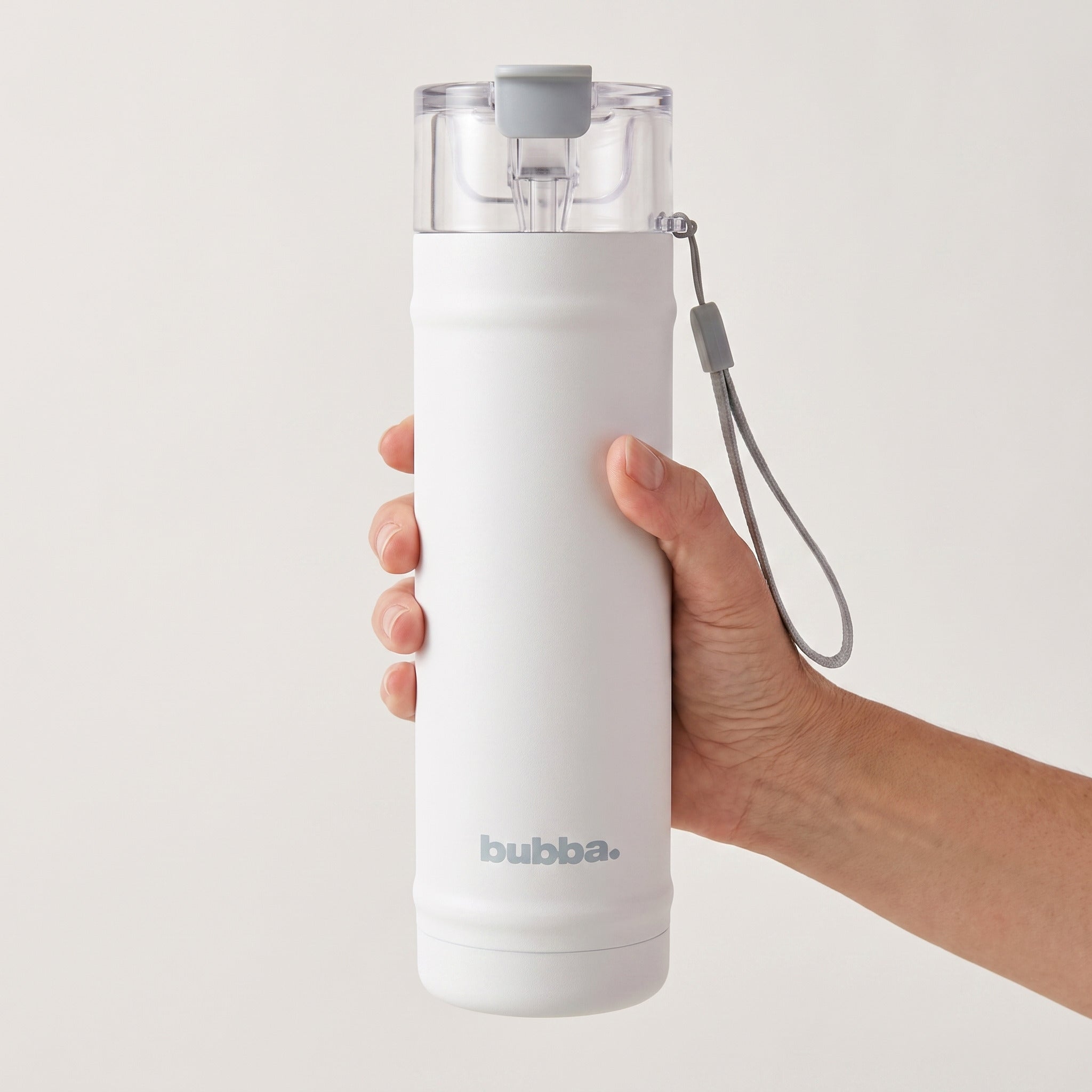 bubba 24 oz DualSip insulated bottle in Fresh Kicks held in an adult hand, showing its real size. It stands 10.79 in tall.