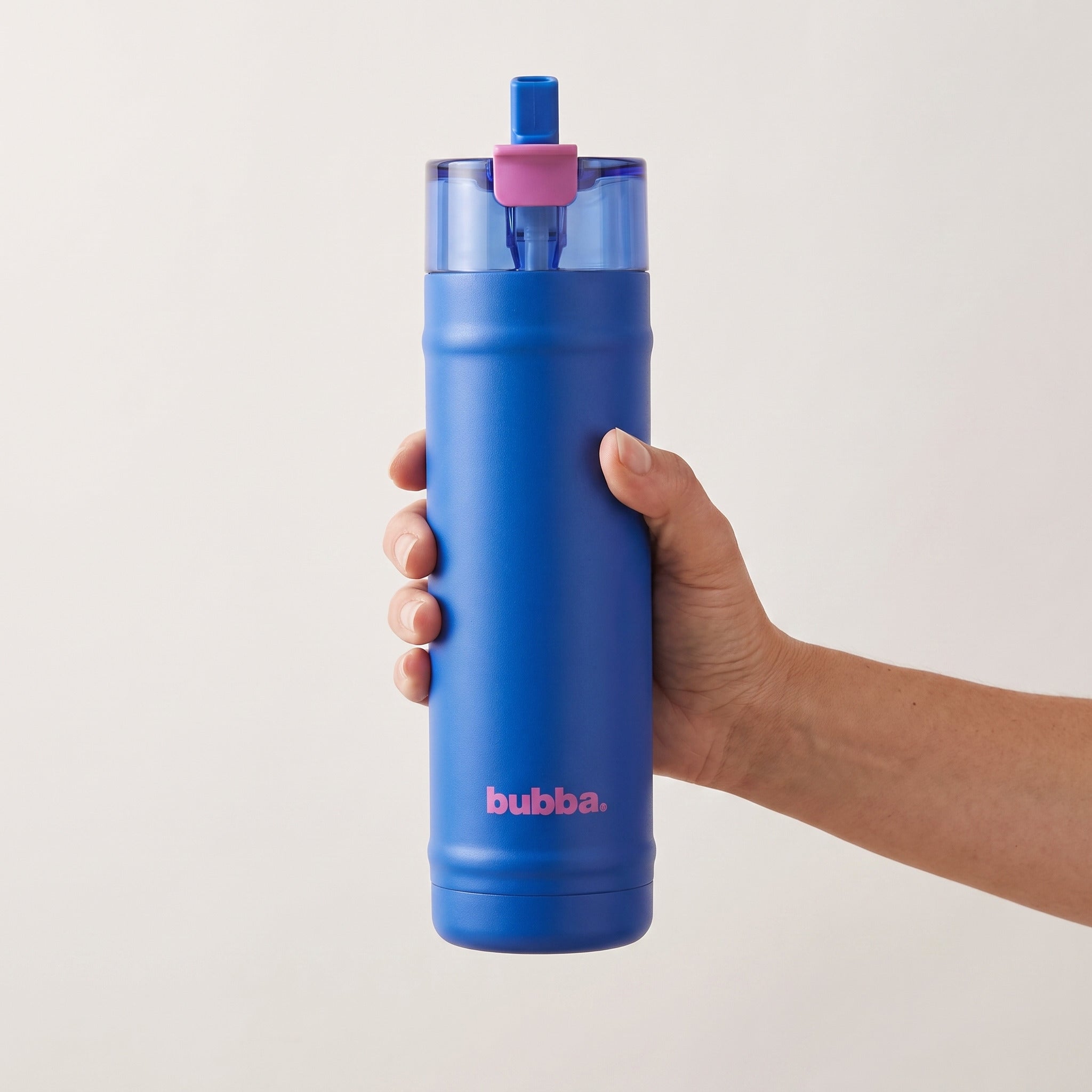 bubba 24 oz DualSip insulated bottle in Ocean Energy held in an adult hand, showing its real size. It stands 10.79 in tall.