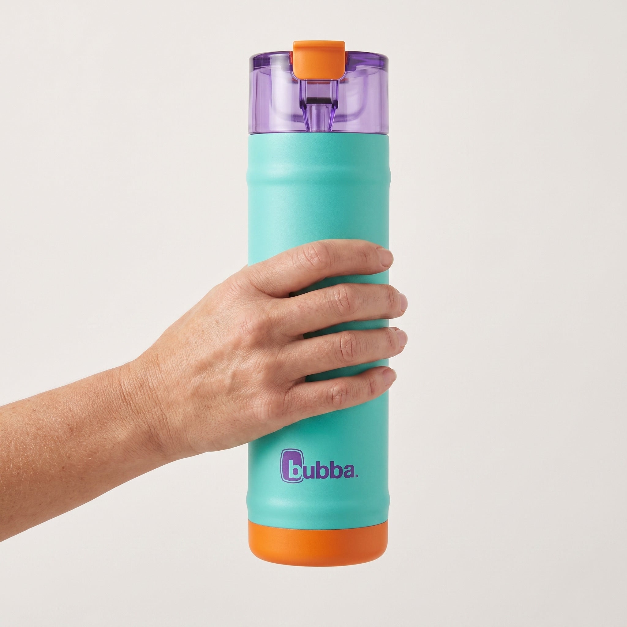 bubba 24 oz DualSip insulated bottle in Field Trip held in an adult hand, showing its real size. It stands 10.79 in tall.