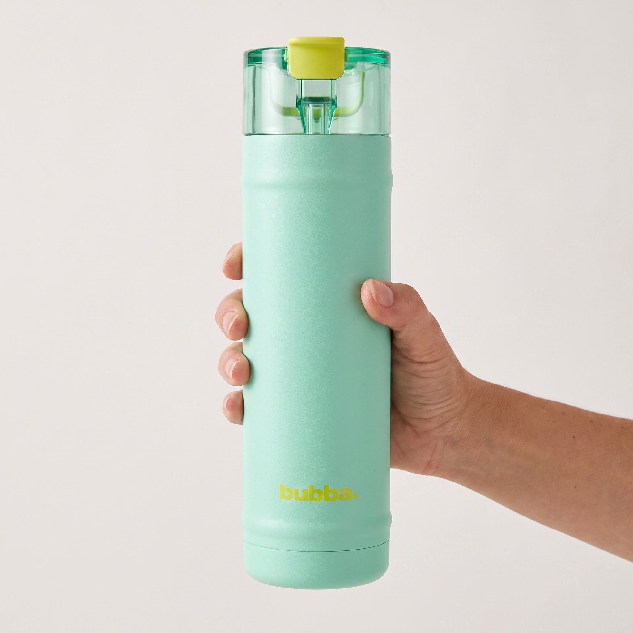 bubba 24 oz DualSip insulated bottle in Tropical Eclipse held in an adult hand, showing its real size. It stands 10.79 in tall.