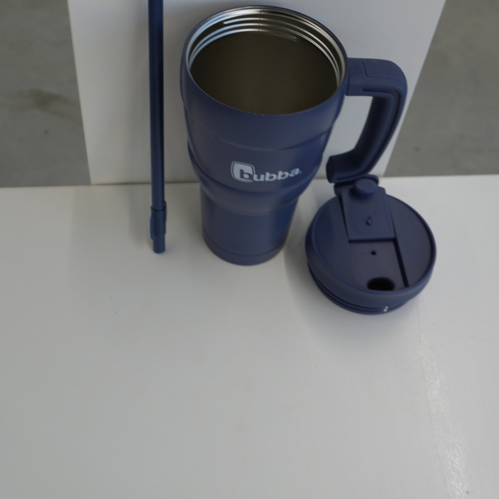 bubba 24 oz Hero XL tumbler in Indigo with the lid off, showing the stainless steel interior and the straw