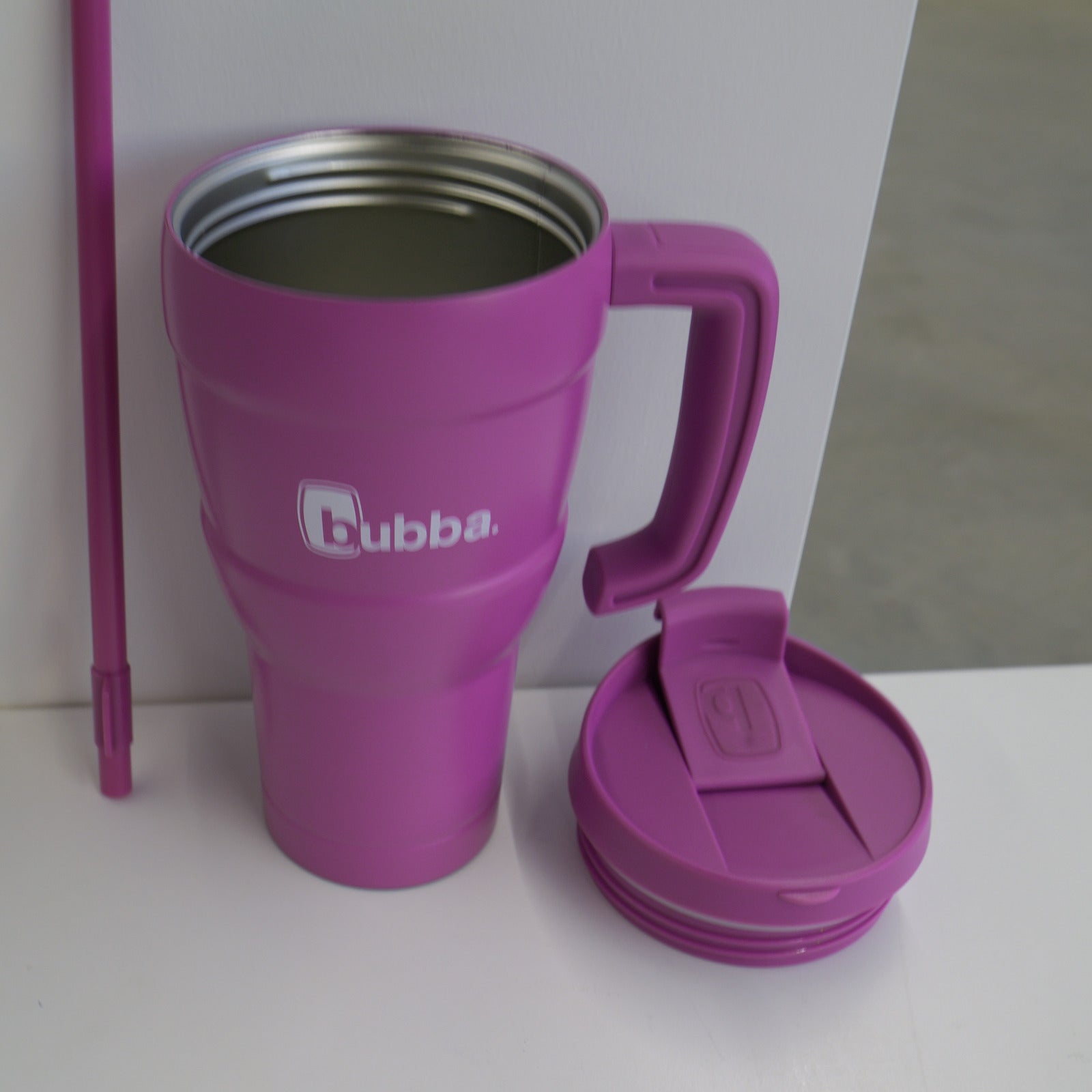 bubba 24 oz Hero XL tumbler in Magenta with the lid and straw set beside it, showing the stainless steel interior