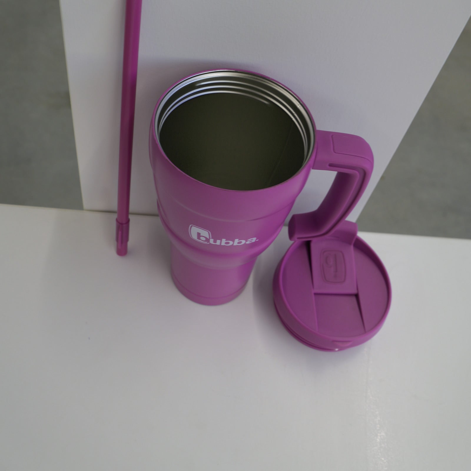 bubba 24 oz Hero XL tumbler in Magenta on its side with the lid removed, showing the wide mouth