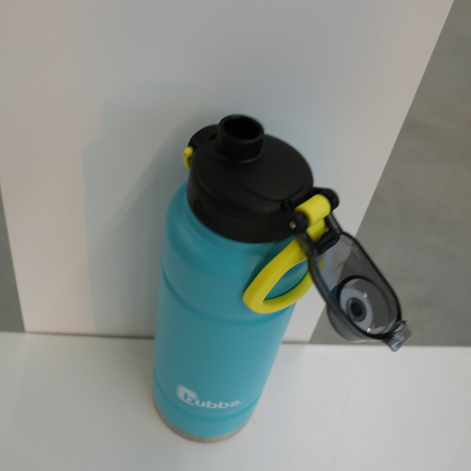 bubba 40 oz Trailblazer in Scuba teal with the lid open, showing the drinking spout and the yellow carry loop
